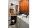 Functional laundry room with washer, dryer, ample counter space, and wooden cabinets at 124 Palm Pl, Haines City, FL 33844