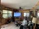 Cozy living room featuring wood paneling, tile floors, and eclectic decor at 124 Palm Pl, Haines City, FL 33844