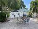 Enjoy outdoor living on this brick patio with a dining set and a vibrant umbrella at 124 Palm Pl, Haines City, FL 33844