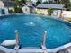 Refreshing above-ground pool featuring clear water with a charming fountain, inviting for a relaxing swim at 124 Palm Pl, Haines City, FL 33844