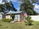 Outdoor shed with rustic design, Rolling Rock mural, and American flag, adding character to the yard at 124 Palm Pl, Haines City, FL 33844