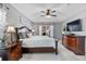 Main bedroom with a king bed, ceiling fan, and sliding glass doors at 1357 Rebecca Dr, Haines City, FL 33844