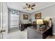 Office space with a large window, wood-look desk, and neutral gray walls, offering a bright workspace at 1357 Rebecca Dr, Haines City, FL 33844