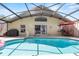 Relaxing screened pool with tiled edge, patio furniture, and outdoor dining at 1357 Rebecca Dr, Haines City, FL 33844