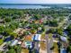 A marked location in an aerial view of a neighborhood near a tranquil lake with lush greenery at 1371 Sheridan Sw St, Winter Haven, FL 33880