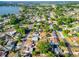 Drone view showing the neighborhood's homes, greenery, and proximity to a large lake at 1371 Sheridan Sw St, Winter Haven, FL 33880
