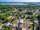 An aerial view of the area, displaying homes near a tranquil lake and lush greenery at 1371 Sheridan Sw St, Winter Haven, FL 33880