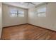 This bedroom has hardwood floors, two bright windows, neutral paint, and overhead ceiling fan at 1371 Sheridan Sw St, Winter Haven, FL 33880