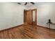 This bedroom boasts pristine hardwood floors, neutral paint, a ceiling fan, and closet at 1371 Sheridan Sw St, Winter Haven, FL 33880