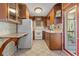 Classic kitchen featuring ample wooden cabinetry, neutral countertops and tile flooring at 1371 Sheridan Sw St, Winter Haven, FL 33880