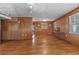 Spacious living room featuring beautiful hardwood floors, wood paneling and ample natural light at 1371 Sheridan Sw St, Winter Haven, FL 33880
