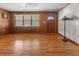 Spacious living room featuring beautiful hardwood floors, wood paneling and ample natural light at 1371 Sheridan Sw St, Winter Haven, FL 33880