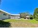 Exterior view of the home featuring the deck, gazebo and a spacious grassy yard at 14 Cypress Run, Haines City, FL 33844