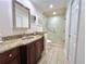 Bathroom featuring granite countertops, dark wood cabinets, and a glass-enclosed shower for a luxurious feel at 14 Cypress Run, Haines City, FL 33844