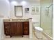 Bathroom featuring granite countertops, dark wood cabinets, and a glass-enclosed shower for a modern look at 14 Cypress Run, Haines City, FL 33844