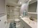 Bathroom showcases a shower, vanity, toilet, neutral wall paint and tiled floors at 14 Cypress Run, Haines City, FL 33844
