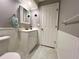 Bathroom features a vanity, tiled floors, mirror, and neutral paint at 14 Cypress Run, Haines City, FL 33844