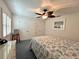 Charming bedroom featuring a ceiling fan, closet, and a comfortable bed creating a restful atmosphere at 14 Cypress Run, Haines City, FL 33844