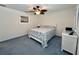 Cozy bedroom with a ceiling fan, a comfortable bed, and a white dresser for a serene retreat at 14 Cypress Run, Haines City, FL 33844