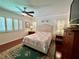 Bright bedroom with wood floors, shutters on the windows, and classic furnishings at 14 Cypress Run, Haines City, FL 33844