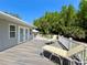 Open-air deck with patio chairs; gazebo and trees in the background at 14 Cypress Run, Haines City, FL 33844