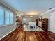Bright dining room with wood floors, gray walls, bar seating and an elegant chandelier at 14 Cypress Run, Haines City, FL 33844