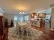 Open floor plan with dining and kitchen area with hardwood floors, modern lighting, and neutral paint at 14 Cypress Run, Haines City, FL 33844