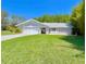 Charming single Gathering home with a well manicured lawn and two-car garage at 14 Cypress Run, Haines City, FL 33844