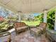 Inside of the gazebo boasts seating and scenic views of the lush greenery and landscaping at 14 Cypress Run, Haines City, FL 33844