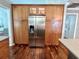 Gourmet kitchen boasts stainless steel refrigerator, wooden cabinets and hardwood floors, and granite countertops at 14 Cypress Run, Haines City, FL 33844