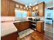 Modern kitchen features wood cabinets, stainless steel appliances, granite countertops, and hardwood floors at 14 Cypress Run, Haines City, FL 33844