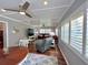 Comfortable living room with modern ceiling fan, wood floors, and bright natural lighting at 14 Cypress Run, Haines City, FL 33844