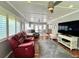 Bright living room featuring coffered ceiling, wood floors, modern fan and comfortable seating at 14 Cypress Run, Haines City, FL 33844