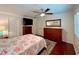 Spacious main bedroom featuring a ceiling fan, dressers, and a comfortable bed, creating a relaxing retreat at 14 Cypress Run, Haines City, FL 33844