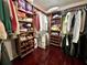 Well-organized walk-in closet with custom shelving, providing ample storage for clothes and accessories at 14 Cypress Run, Haines City, FL 33844