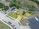Aerial view of a yellow home with a driveway and walkway, and solar panels at 147 Brookshire Dr, Lake Wales, FL 33898