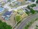 This is an aerial view of a home with a large backyard, solar panels and a community neighborhood at 147 Brookshire Dr, Lake Wales, FL 33898