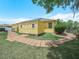 Yellow backyard shed with solar panels and brick pathway, blending functionality with charm at 147 Brookshire Dr, Lake Wales, FL 33898