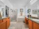 Bathroom featuring double sinks, a walk-in shower, a soaking tub, and tile floors at 147 Brookshire Dr, Lake Wales, FL 33898