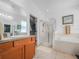 Bright bathroom featuring walk-in shower, soaking tub, and vanity with modern fixtures at 147 Brookshire Dr, Lake Wales, FL 33898