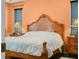 Bedroom with a wooden bed frame, dark wood floors, and a large window for natural light at 147 Brookshire Dr, Lake Wales, FL 33898