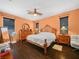 Traditional bedroom with dark wood floors, a ceiling fan, and natural light from the window at 147 Brookshire Dr, Lake Wales, FL 33898