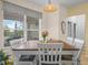 Bright dining room with a large window, neutral colors, and a vase of colorful flowers at 147 Brookshire Dr, Lake Wales, FL 33898