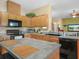 Spacious kitchen with wooden cabinetry, black appliances, and an island at 147 Brookshire Dr, Lake Wales, FL 33898
