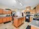 Well-lit kitchen with an island, wooden cabinetry, and stainless steel appliances at 147 Brookshire Dr, Lake Wales, FL 33898