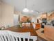 Bright kitchen and dining area with wood cabinets, pendant lighting, and stainless steel appliances at 147 Brookshire Dr, Lake Wales, FL 33898