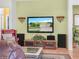 Cozy living room with entertainment center, leather seating, and tiled floors at 147 Brookshire Dr, Lake Wales, FL 33898