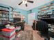 Office with a ceiling fan, a light wood floor, and plenty of shelving for storage and organization at 147 Brookshire Dr, Lake Wales, FL 33898