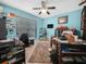 Cozy office space featuring a ceiling fan, blue walls, and a large window for natural light at 147 Brookshire Dr, Lake Wales, FL 33898