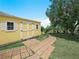 Backyard shed with brick pathway, providing extra storage and a charming aesthetic at 147 Brookshire Dr, Lake Wales, FL 33898